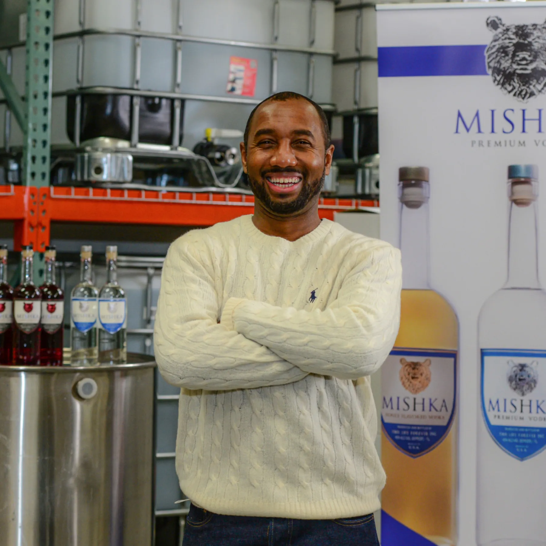 Man in front of vodka bottle display