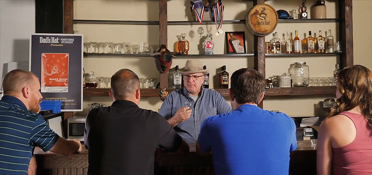 Dad's Hat Tasting event with four people sitting at the bar and one server