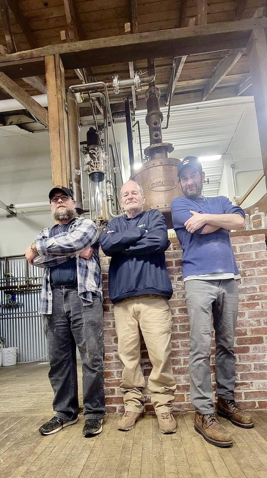 3 men standing next to each other at Stoll and wolfe distillers